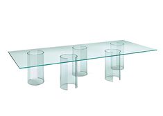 a glass table with four vases on it