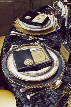 black and gold table setting with place settings