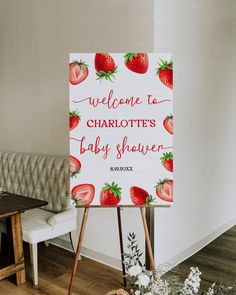 a welcome sign for a baby shower with strawberries on it