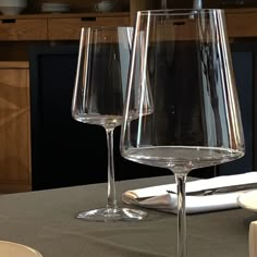 two wine glasses sitting on top of a table