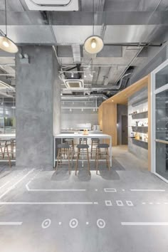 an office with concrete walls and flooring