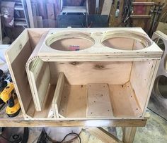 an unfinished cabinet is being built in a workshop