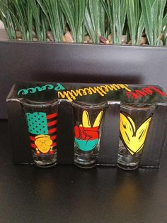 three shot glasses sitting on top of a table