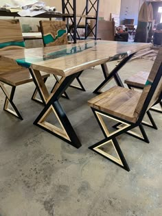 a wooden table with chairs around it in a room filled with other tables and chairs