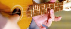 a person playing an acoustic guitar with their fingers