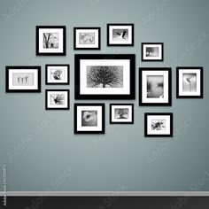 black and white photo frames arranged on the wall