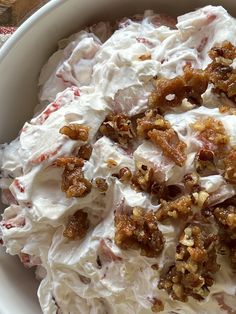 a white bowl filled with whipped cream and toppings