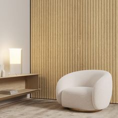 a white chair sitting in the middle of a living room next to a wall with vertical blinds