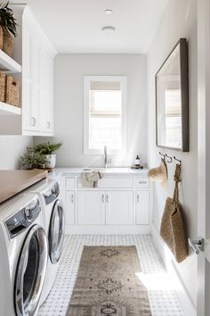 a washer and dryer in a white laundry room