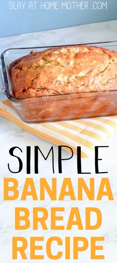 a loaf of banana bread sitting on top of a counter next to a glass pan