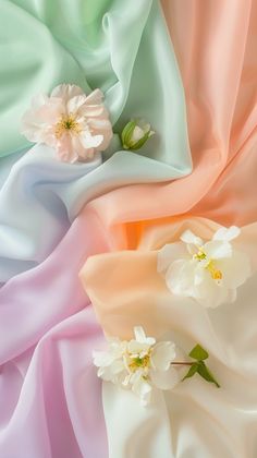 an image of colorful fabric with flowers on it's side and one flower in the middle