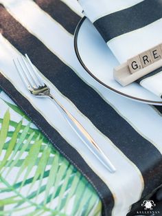 a table setting with silverware and napkins on it, including a fork and knife