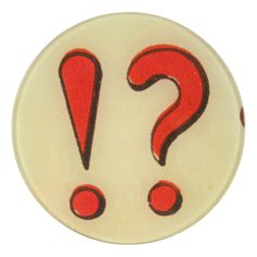 a white button with red question marks on it's center and two black dots in the middle