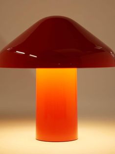 an orange lamp sitting on top of a table