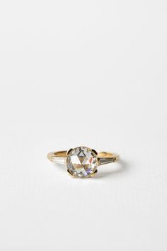 a gold ring with an oval cut diamond