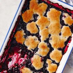 blueberry cobbler in a baking dish with crumbs on top