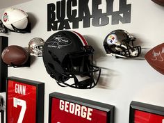 a football helmet mounted to the side of a wall with other sports memorabilia on it