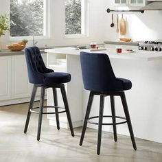 two blue chairs sitting on top of a kitchen counter