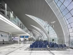 there are many blue chairs in the airport