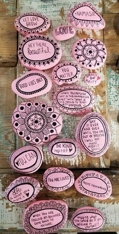 some pink stickers with words on them