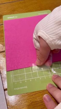 a person is cutting paper with a pair of scissors