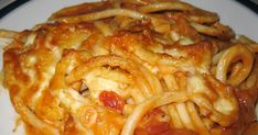 a plate full of pasta with sauce and cheese on the top is ready to be eaten