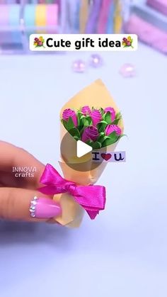 a person holding a fake flower in their hand with the caption cute gift idea