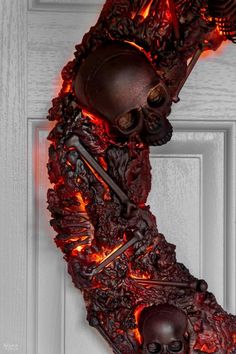 a door with a skeleton hanging from it's side and fire coming out of the top