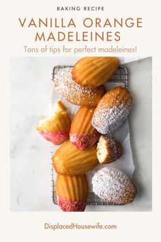 vanilla orange madeleines on a cooling rack with powdered sugar