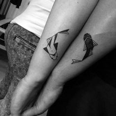 two people with matching tattoos on their arms