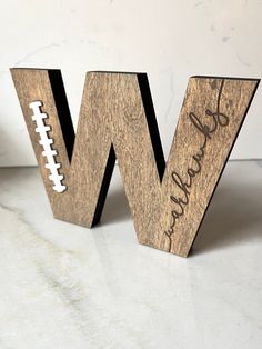 a wooden letter with a football on it