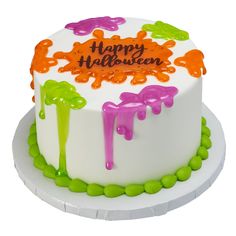 a white cake with orange and green icing that says happy halloween on it's top