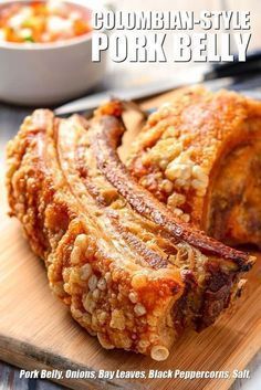 pork belly on a cutting board with other dishes in the background and title text overlay