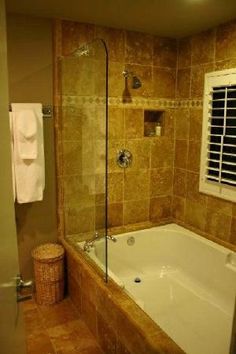 a bath tub sitting next to a window in a bathroom