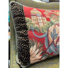 a close up of a cushion on a chair with an animal print pattern and black trim