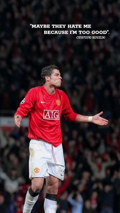 a man in a red shirt is on the soccer field with his arms out and hands outstretched