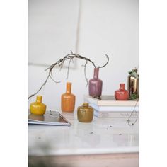 some vases and books on a table