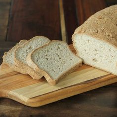 a loaf of bread sitting on top of a wooden cutting board