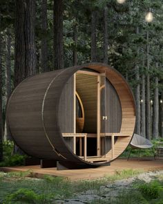 a round wooden structure in the middle of a forest