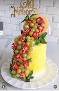 a cake decorated with grapes and flowers on a plate