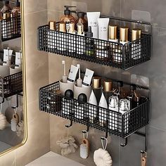 two black metal baskets filled with personal care items next to a bathroom sink and mirror