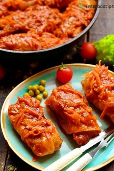 three pieces of meat on a plate next to some vegetables and sauce in a pan