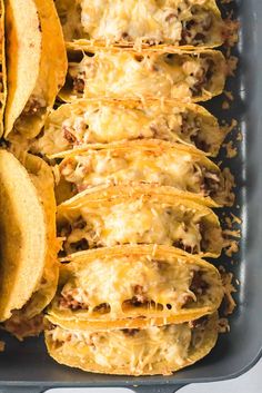 several tortilla shells in a baking dish with cheese and meat on top, ready to be eaten