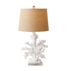 a white coral lamp with a beige shade