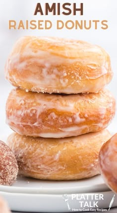 three glazed donuts stacked on top of each other with the words, amish raised doughnuts