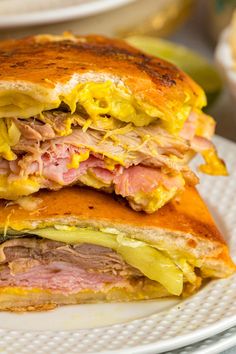 a sandwich cut in half sitting on top of a white plate