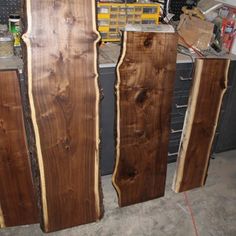 three pieces of wood sitting next to each other on top of a workbench