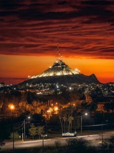 a view of a mountain at night with lights on