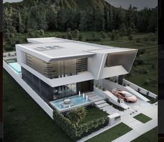 an aerial view of a modern house with a pool in the front yard and mountains in the background