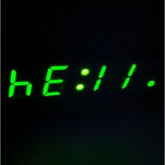 the word he is written in green on a black background